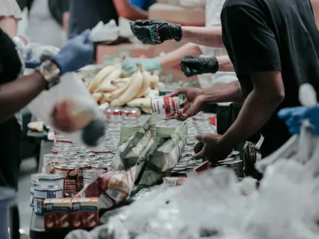 Volunteers sorting donated canned food at a food bank